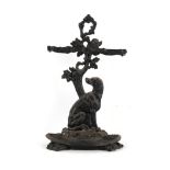 Property of a lady - a black painted ornate cast iron hound stick stand, with loose tray.