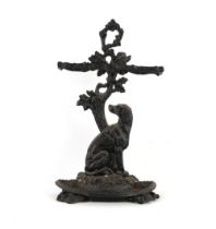 Property of a lady - a black painted ornate cast iron hound stick stand, with loose tray.