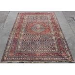 Property of a lady - a large antique Persian Khorassan carpet, 193 by 133ins. (490 by 338cms.).