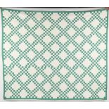 Property of a lady - a large green & white geometric patchwork quilt, probably late 19th century, in