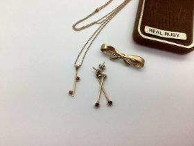 A 9ct Gold Bow Style Brooch, a 9ct Gold claw set drop pendant on a chain, with matching claw set