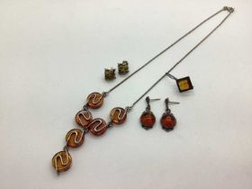 A Modernist Style Amber Coloured Drop Necklace, together with a pair of amber coloured stud earrings