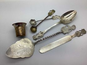 A Pastry Server, with figural and twisted handle, stamped "800"; together with spoons with