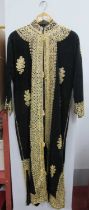 Middle Eastern Full Length Black Gown, extensively foliate decorated in gilt braid.