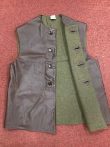 Post-war British Army unissued PVC jerkin with label showing broad military arrow, manufacturer -