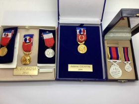 Four Boxed French Labour Medals, together with a Malaysian Peacekeeping medal with a matching