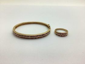 A Modern 9ct Gold Hinged Bangle, two row alternately set to the front, hinged to snap clasp (