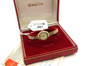 Omega; A 9ct Gold Cased Ladies Wristwatch, the signed dial with Arabic numerals and dot markers,