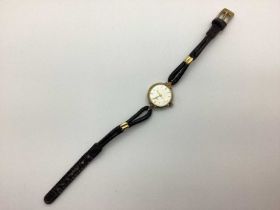 A Vintage 9ct Gold Cased Wristwatch, the round dial with patterned minimalist design, movement