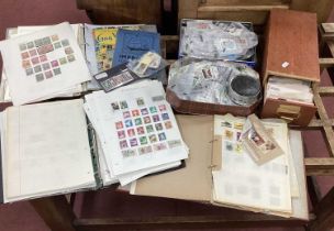 Stamps; An assortment of world stamps, early to modern, housed in three loose leaf albums, two