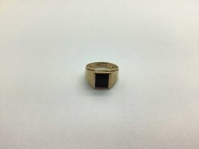 A Signet Style Ring, with inset rectangular panel, between plain tapering shoulders, inside shank