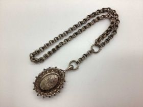 A Victorian Oval Locket Pendant, textured and leaf scroll engraved decoration, stamped "Std Silr",