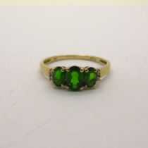 A Modern Diopside Three Stone Dress Ring, with inset highlights, stamped "9k" "Dia" (finger size