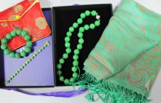 A Modern Burmese Green Jade Bead Necklace, of uniform design, knotted to magnetic clasp, together