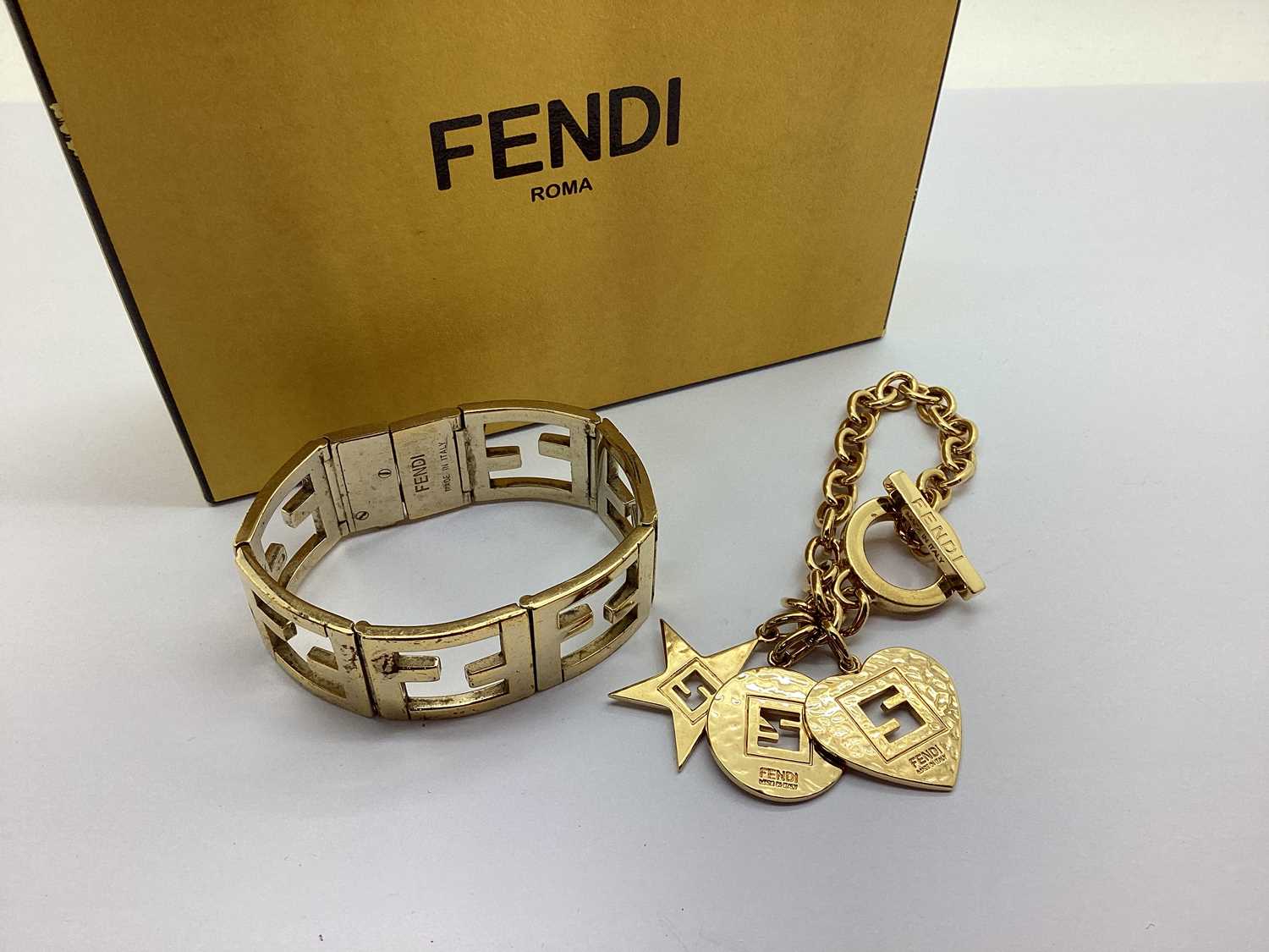 Fendi; A Modern Bracelet, to T-bar and loop fastener; together with a Fendi panel bracelet (clasp