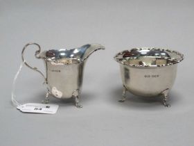 A Hallmarked Silver Jug and Sugar Bowl, Reid & Sons, London 1920, each with wavy edge, raised on