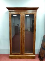 A XIX Century Mahogany Bookcase, with glazed doors and five adjustable shelves on a plinth base,