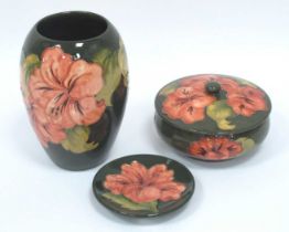 A Moorcroft Pottery Vase, of ovoid form, painted in the 'Coral Hibiscus' pattern against a green