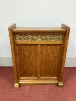 A XX Century Oak Book Stand, with a slightly sloping top and frieze with gilt winged angel and