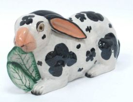 A Mid XIX Century Staffordshire Pottery Model of a Rabbit, modelled eating lettuce leaves, painted