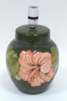 A Moorcroft Pottery Table Lamp, painted in the 'Coral Hibiscus' pattern against a green ground,