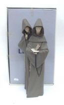 A Lladro Figure Group of Monks, in matt finish, 37.5cm high, with box.