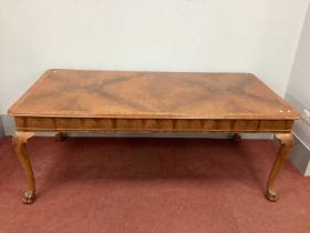 A XX Century Rectangular Walnut Dining Table, with moulded edge and crossbanded top on carved