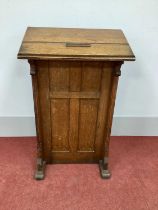 An Early XX Century Oak Lectern, with sloping top and shaped sides, panelled front, 112cm high, 60cm