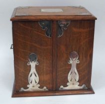 An Early XX Century Oak Cased Smokers Cabinet, of rectangular form with plated mounts and side