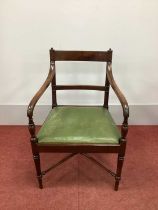 An Early XIX Century Mahogany Carver Chair, with rectangular top rail, shaped arms and drop-in seat,