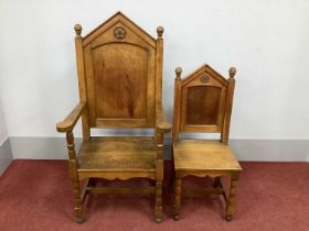 A XX Century Oak Armchair, with turned finials and rose carving over panelled back, pade arms and