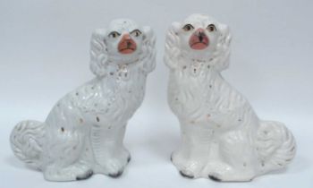 A Pair of Late XIX Century Staffordshire Spaniels, with painted features and moulded collars and