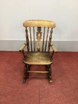 A XIX Century Ash and Elm Child's Rocking Chair, with pierced splat, rail supports and turned