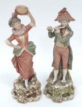 A Pair of Royal Dux Porcelain Figures of a Lady and Gentleman, he playing the flute, she a