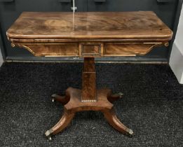 A XIX Century Mahogany Tea Table, with fold-over top and baized interior, the frieze with brass