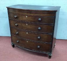 An Early XIX Century Mahogany Bow Fronted Chest of Drawers, with four drawers on tapering block