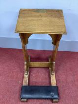 A XX Century Oak Littany Desk, with sloping top, shaped sides and kneeler, on side rails, 85cm high,