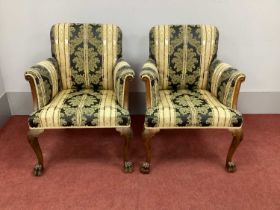 A Pair of XVIII Century Style Walnut Armchairs, upholstered in a striped damask fabric, on carved