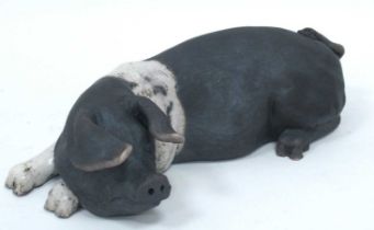 Lawson C. Rudge (b.1936) *ARR; A Raku Pottery Reclining Saddleback Pig, signed, 22cm long,