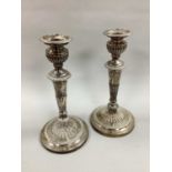 A Pair of Plated on Copper Candlesticks, each with tapering stem, with gadrooned detail, on circular