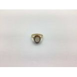 A 9ct Gold Cluster Ring, oval claw set centre, within claw set border, between tapered shoulders (