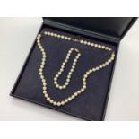 A Knotted Cultured Pearl Necklace, clasp stamped "375"; together with a knotted cultured pearl