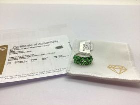 The Genuine Gemstone Company Ltd; A 9ct Gold Tsavorite Garnet Cluster Ring, the oval cut stones over