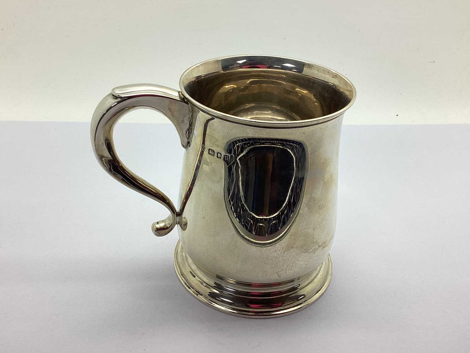 A Hallmarked Silver Mug, London 1928, of plain tapering form, with scroll handle, spreading base,