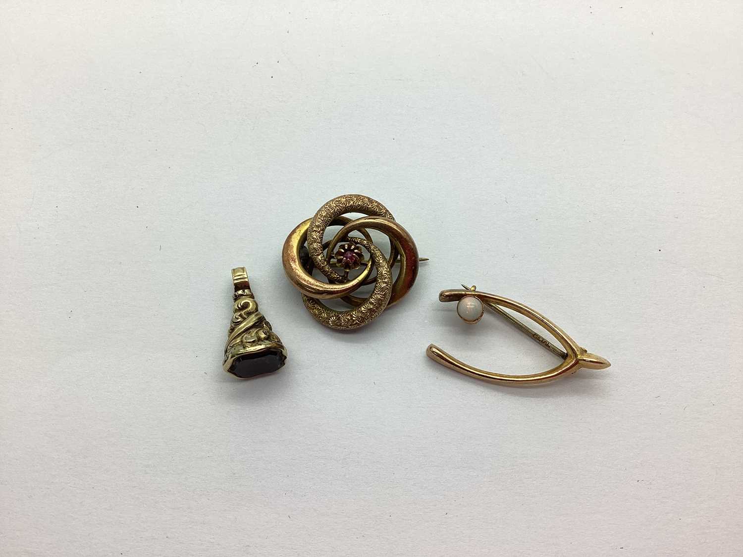 A 9ct Gold Stone Set Wishbone Brooch, to pin stamped "METAL"; together with a seal fob of ornate