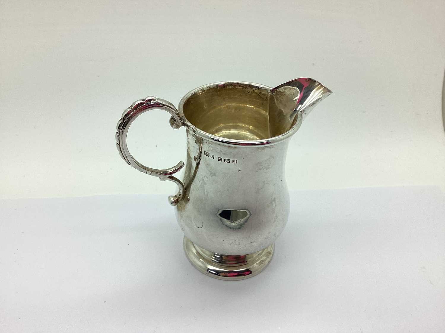 A Hallmarked Silver Jug, ALD, Birmingham 1932, of plain baluster form with scroll handle, on