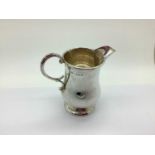 A Hallmarked Silver Jug, ALD, Birmingham 1932, of plain baluster form with scroll handle, on