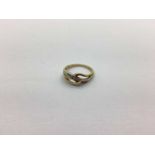 A Two-Tone Stone Set Crossover Ring, stamped "9K DIA", (finger size Q) (2.8grams).