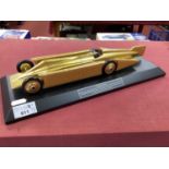 A Bravo Delta Models Golden Arrow Land Speed Record Car, 35cm length, scratches to plinth noted,