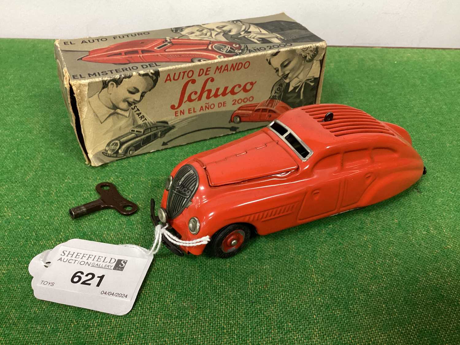 A Post War Tinplate Clockwork Schuco 'Ano 2000', red, working, overall very good, boxed with key.